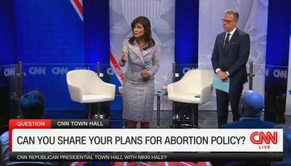 Nikki Haley and Jake Tapper are standing on a town hall stage with a chyron reading "Can you share your plans for abortion policy?