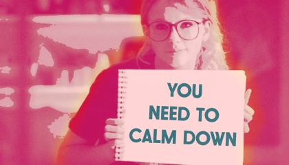 Taylor Swift holding  a sign that says you need to calm down 